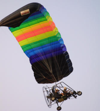 Two seat 582 powered powered parachute flying at the E.A.A. Sun N Fun convention.