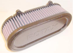 Its shorter profile helps support the carbs and taking some of the load off of the intake sockets. Note the tabs for safety wiring the airfilter to the carbs.